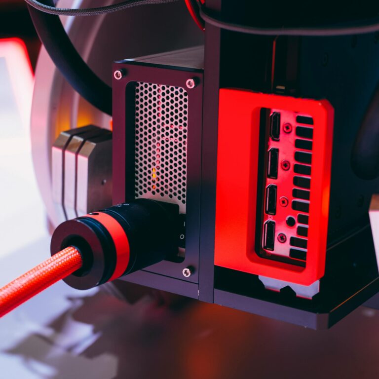 Detailed image of a high-tech computer component with red accents and cable connections.